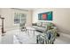 A cozy living room featuring a comfortable sofa, two accent chairs, and a decorative white rug at 1191 Crofton Lndg, Suwanee, GA 30024