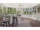 Enjoy this screened in porch with wooded views, ceiling fan, porch swing and dining area at 1191 Crofton Lndg, Suwanee, GA 30024