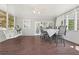 Enjoy this screened in porch with wooded views, porch swing and dining area at 1191 Crofton Lndg, Suwanee, GA 30024