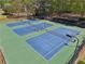 Aerial view of three community tennis courts, perfect for tennis enthusiasts at 1191 Crofton Lndg, Suwanee, GA 30024