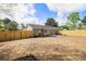 The backyard features a new fence, large lot, and patio area, offering privacy and outdoor enjoyment at 1857 Taffeta Trl, Lithonia, GA 30058