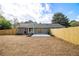 Fenced backyard features a new patio and fresh landscaping, creating an inviting outdoor oasis at 1857 Taffeta Trl, Lithonia, GA 30058