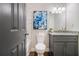 Bathroom features modern toilet, stylish granite counter, and tiled shower accents, enhancing its functionality and elegance at 1857 Taffeta Trl, Lithonia, GA 30058