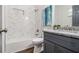 Bathroom with marble tiled shower and gray vanity with granite countertop at 1857 Taffeta Trl, Lithonia, GA 30058
