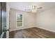 Bedroom features a ceiling fan, wooden floors, and natural light streaming in, creating a relaxing and airy space at 1857 Taffeta Trl, Lithonia, GA 30058