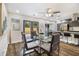 Bright dining room with modern décor, glass table set, hardwood floors, and patio door access at 1857 Taffeta Trl, Lithonia, GA 30058