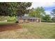 Charming single-story home with manicured lawn, enhanced by lovely landscaping, and an extended driveway at 1857 Taffeta Trl, Lithonia, GA 30058