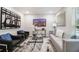 Comfortable living room featuring a large abstract art piece, modern seating, and a large TV at 1857 Taffeta Trl, Lithonia, GA 30058