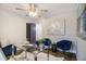 Home office with hardwood floors, modern glass desk, and blue accent chairs at 1857 Taffeta Trl, Lithonia, GA 30058