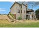 Beautiful backyard featuring a lush lawn, stairs, stone walkway, and deck with stairs at 1870 Marcia Overlook Dr, Cumming, GA 30041