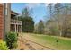 Manicured backyard featuring a lush lawn, stone walkway, and trees, offering a serene outdoor space at 1870 Marcia Overlook Dr, Cumming, GA 30041