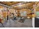 Basement gym featuring various equipment, exposed framing, and open ceilings for a functional workout space at 1870 Marcia Overlook Dr, Cumming, GA 30041