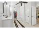 Bathroom with a double vanity, tile floors, a ceiling fan, and access to a walk-in closet at 1870 Marcia Overlook Dr, Cumming, GA 30041