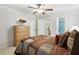 Cozy bedroom featuring a ceiling fan, warm lighting, and neutral walls at 1870 Marcia Overlook Dr, Cumming, GA 30041