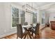 Bright dining area with a glass-topped table, modern lighting, and natural light at 1870 Marcia Overlook Dr, Cumming, GA 30041