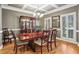 Elegant dining room with hardwood floors, coffered ceilings, and sophisticated lighting fixtures at 1870 Marcia Overlook Dr, Cumming, GA 30041