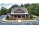 Exterior of a beautiful clubhouse features covered entrance, lush landscaping and paved parking lot at 1870 Marcia Overlook Dr, Cumming, GA 30041