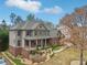 Stately two-story home with a covered porch, brick accents, and professional landscaping at 1870 Marcia Overlook Dr, Cumming, GA 30041
