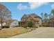 Lovely two-story home with a manicured lawn, a long driveway, and mature trees at 1870 Marcia Overlook Dr, Cumming, GA 30041
