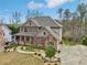 Charming two-story home with a covered porch, brick accents, and well-manicured landscaping at 1870 Marcia Overlook Dr, Cumming, GA 30041