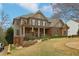 Beautiful two-story home with brick and siding exterior, a cozy porch, and a manicured front yard at 1870 Marcia Overlook Dr, Cumming, GA 30041