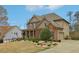Charming two-story home with brick and siding exterior, a well-manicured lawn and inviting front porch at 1870 Marcia Overlook Dr, Cumming, GA 30041