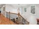 Upstairs hallway with hardwood floors and iron railing at 1870 Marcia Overlook Dr, Cumming, GA 30041