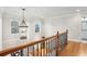 Bright hallway featuring hardwood floors, a decorative chandelier, and views of the outside at 1870 Marcia Overlook Dr, Cumming, GA 30041