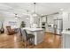 Bright kitchen featuring an island with seating, stainless steel appliances, and hardwood floors at 1870 Marcia Overlook Dr, Cumming, GA 30041