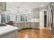 Bright, open kitchen with stainless steel appliances and an adjacent dining area with plentiful natural light at 1870 Marcia Overlook Dr, Cumming, GA 30041