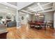 Open-concept living space featuring hardwood floors, a coffered ceiling, and a cozy fireplace at 1870 Marcia Overlook Dr, Cumming, GA 30041