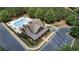 Aerial shot of a community pool showcases relaxing amenities amidst lush greenery and a clubhouse at 1870 Marcia Overlook Dr, Cumming, GA 30041