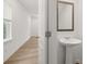 Half bathroom with pedestal sink and wood-look flooring at 321 Daybreak Dr, Acworth, GA 30102