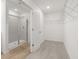 Bathroom showing walk in shower, wood-look floor, and wire shelving in walk in closet at 321 Daybreak Dr, Acworth, GA 30102
