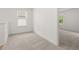 Bright bedroom featuring neutral carpet, natural light from a window, and white trim at 321 Daybreak Dr, Acworth, GA 30102