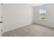 This bedroom boasts neutral walls, plush carpet, and natural light from the window at 321 Daybreak Dr, Acworth, GA 30102