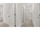Hallway with white walls and doors, and neutral carpet leading to rooms with natural light at 321 Daybreak Dr, Acworth, GA 30102