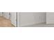 Hallway featuring wood look flooring, white trim and neutral paint at 321 Daybreak Dr, Acworth, GA 30102