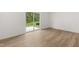 Living room with wood-look floors and a view to the backyard and patio at 321 Daybreak Dr, Acworth, GA 30102