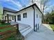 Exterior elevation of the home showcasing the freshly painted white brick and craftsman details at 438 Holly Nw St, Atlanta, GA 30318