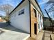 A look at the back of the house showcasing the white brick, dark gutters, and wooden deck at 438 Holly Nw St, Atlanta, GA 30318