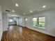 Open-concept living area flows into the kitchen, with beautiful wood floors at 438 Holly Nw St, Atlanta, GA 30318