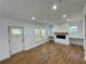Bright living room with wood floors, a fireplace, and custom shelving at 438 Holly Nw St, Atlanta, GA 30318
