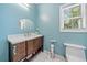 Charming bathroom featuring a modern vanity, sleek mirror, and a toilet for added convenience at 717 Chamberlain Sw Cir, Marietta, GA 30008
