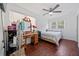 A bright bedroom with windows, a ceiling fan, and dark wood floors at 717 Chamberlain Sw Cir, Marietta, GA 30008