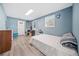 A bedroom featuring a bed, wooden floors, and large windows at 717 Chamberlain Sw Cir, Marietta, GA 30008