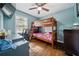 Well-designed bedroom featuring a bunk bed, desk, and hardwood floors, creating a fun and functional space at 717 Chamberlain Sw Cir, Marietta, GA 30008