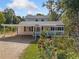 Charming exterior elevation featuring a white house with a yard and gravel driveway at 717 Chamberlain Sw Cir, Marietta, GA 30008