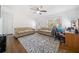 Cozy living room with hardwood floors, featuring two couches and a ceiling fan for added comfort at 717 Chamberlain Sw Cir, Marietta, GA 30008