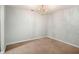 Cozy dining room with a chandelier, neutral walls, and carpet flooring at 13304 Waldrop Cv, Decatur, GA 30034